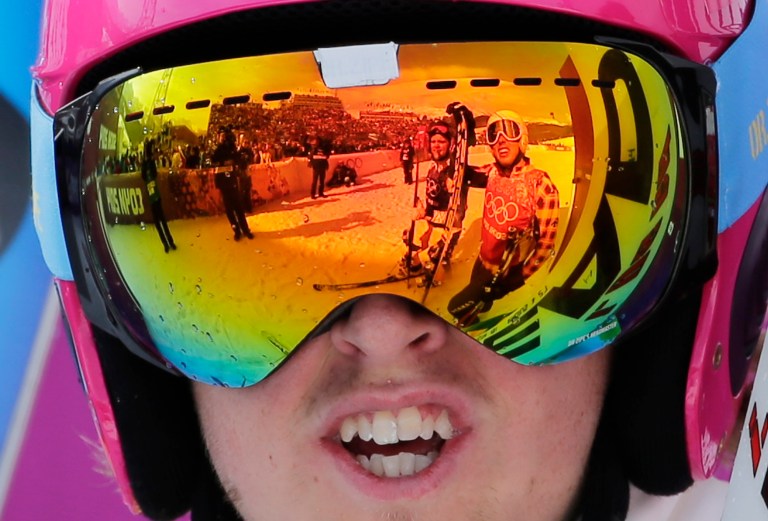 Canada's David Duncan, right, is reflected in the goggles of Sweden's John Eklund after their heat during men's ski cross competition at the Rosa Khutor Extreme Park, at the 2014 Winter Olympics, Thursday, Feb. 20, 2014, in Krasnaya Polyana, Russia. (AP Photo/Andy Wong)