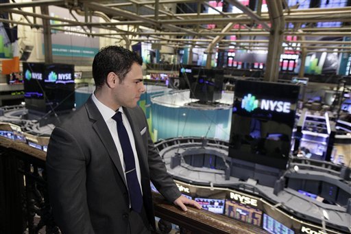 In this Wednesday, Aug. 1, 2012 photo, New York Stock Exchange Senior Compliance Associate Matthew Pizzo, an Air Force veteran who has law and business degrees, looks over the trading floor of the New York Stock Exchange. Pizzo had gone two years without work, until recently, as he is now finishing his first week of work at the exchange. U.S. employers added 163,000 jobs in July, a hopeful sign after three months of sluggish hiring. (AP Photo/Richard Drew)