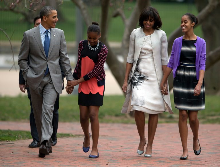President Barack Obama and first lady Michelle Obama walk from the White House with their daughters Sasha Obama, second from left, and Malia Obama, right, on their way through Lafayette Park to St. John's Episcopal Church for Easter services, Sunday, March 31, 2013, in Washington. (AP Photo/Carolyn Kaster)