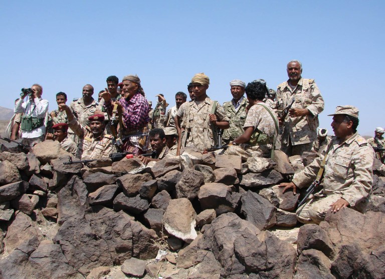 In this handout photo provided by Yemen's Defense Ministry, Yemeni troops take position during the fight against al-Qaida militants in the southern province of Shabwa, Yemen, Wednesday, April 30, 2014. Yemeni military on Tuesday, April 29, launched a major offensive targeting al-Qaida hideouts and strongholds, killing at least eight suspected militants, security officials said. (AP Photo/Yemen Defense Ministry)