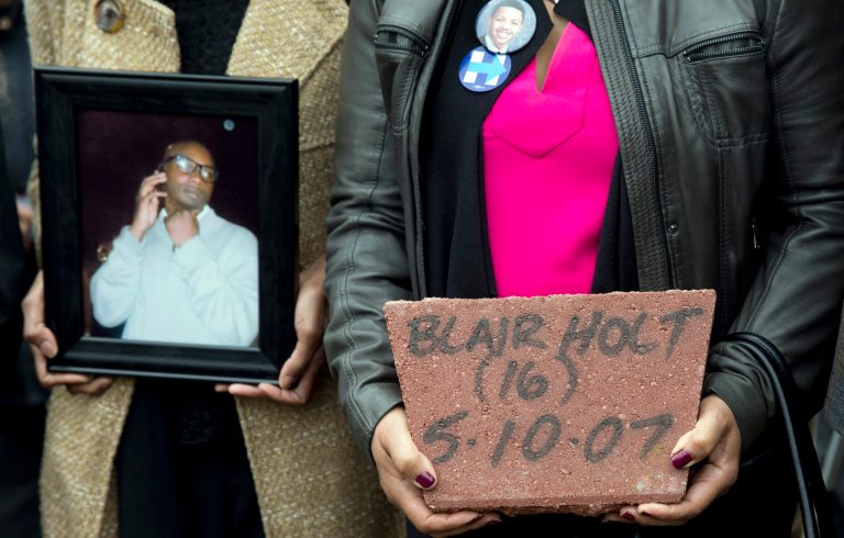 The mother of Blair Holt holds his stone that is part of the Kids off the Block memorial dedicated to victims of violence in Chicago, Monday, March 14, 2016. (AP Photo/Carolyn Kaster)
