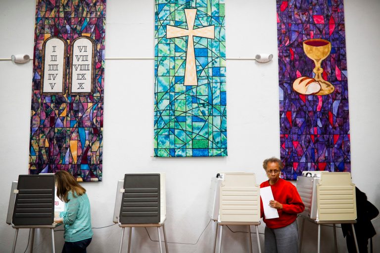 Virgina Price steps away from a voting booth after filling out her ballot at a polling place inside the Pleasant Ridge Presbyterian Church on Election Day, Tuesday, Nov. 8, 2016, in Cincinnati. (AP Photo/John Minchillo)