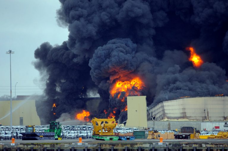 Firefighters battle a blaze in a warehouse at the Georgia Ports Authority Ocean Terminal, Saturday, Feb. 8, 2014, in Savannah, Ga. (AP Photo/Stephen B. Morton)