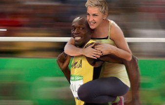 Ellen DeGeneres was accused of racism because slavery used to be a thing in the U.S. and her photo involved her, a white person, riding on the back of Usain Bolt, who is black. (Photo via Twitter)
