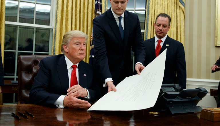 President Trump took a series of executive actions minutes after the inaugural parade concluded Friday evening, one of which was to place a regulatory freeze on all federal agencies until his administration provides further notice. (AP Photo/Evan Vucci)