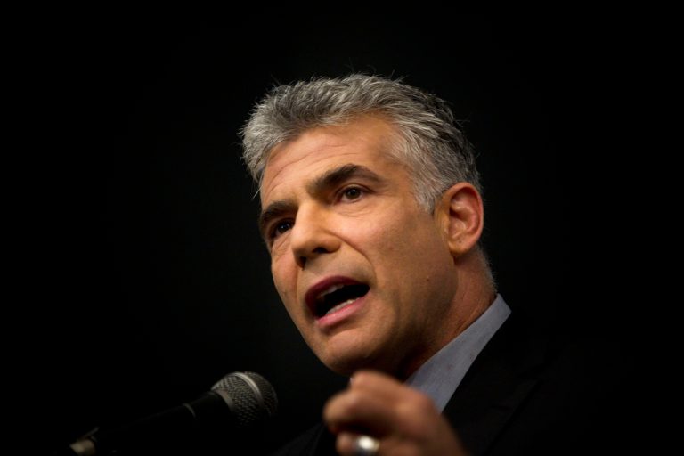 FILE - in this Tuesday, Oct. 30, 2012 file photo, Israeli Yair Lapid, popular former TV anchorman, now Israel's finance minister, delivers a speech in the Ariel college of Judea and Samaria in the West Bank Jewish settlement of Ariel. A cultural war has erupted between Israel's rising political star and his ultra-Orthodox archrivals: newly minted Finance Minister Yair Lapid, hugely popular for opposing the longstanding preferential treatment enjoyed by the growing religious minority, is moving swiftly to slash state handouts to large families, compel lifelong seminary students to work and remove funding for schools that don't teach math, science and English. (AP Photo/Ariel Schalit, File)