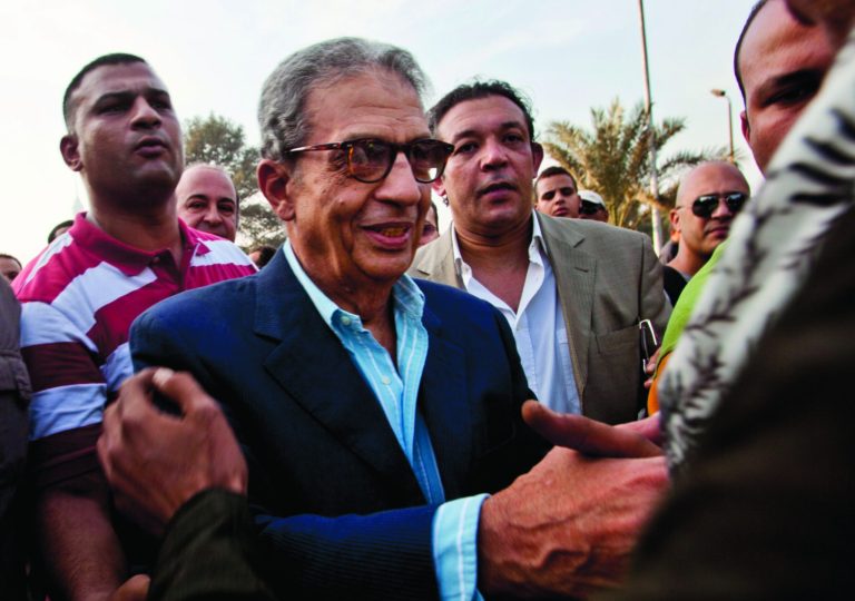 FILE - In this Friday, Nov. 30, 2012 file photo, former foreign minister and presidential candidate Amr Moussa, center, greets supporters as he arrives to Tahrir Square to join other liberal and secular parties for a major protest against Egyptian President Mohammed Morsi's latest decrees granting himself almost complete powers and allowing a rushed constitution to be presented for a vote. An Egyptian official says the country's top prosecutor has ordered an investigation into accusations against opposition leaders, Mohammed ElBaradei, Amr Moussa, and Hamdeen Sabahi, of incitement to overthrow the regime. (AP Photo/Thomas Hartwell, File)