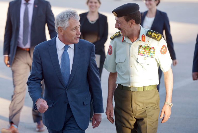 U.S. Secretary of Defense Chuck Hagel is welcomed by Jordan's Chairman of Defense Lieutenant General Mashal al-Zaben, right, upon his arrival at Marka International Airport in Amman, Jordan, Wednesday, May 14, 2014. Hagel is on a regional tour focusing on Iran's nuclear programm and Syria's civil war. (AP Photo/Mandel Ngan, Pool)