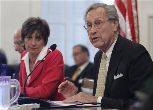 University of Virginia Board of Visitors member W. Haywood Fralin, right, reads a resolution as Rector Helen Dragas, left, listens during a meeting at the rotunda at the school Tuesday, June 26, 2012 in Charlottesville, Va. The Board voted to reinstate president Teresa Sullivan. (AP Photo/Steve Helber)