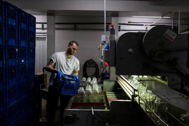 Bryce Rohrer, 19, of Boonsboro, puts empty bottles through the cleaner at South Mountain Creamery in Middletown, Maryland, on April 16. 