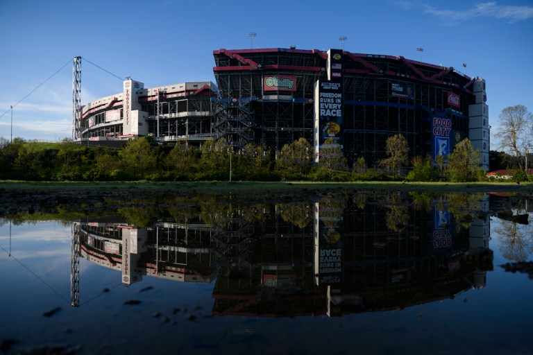 The Bristol Motor Speedway is reflected in a puddle at the camping site on May 2.