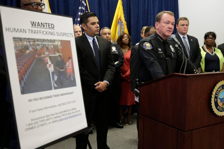 Long Beach Police Chief Jim McDonnell, right, joined by mayor Robert Garcia, center, speaks during a news conference held at Long Beach Police Department headquarters Wednesday, Sept. 24, 2014, in Long Beach, Calif. Authorities said a crackdown on sex trafficking in Southern California has led to 91 arrests and the rescue of nearly two dozen children who had been forced into prostitution. (AP Photo/Jae C. Hong)
