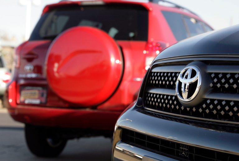   FILE- In this Nov. 26, 2006, file photo, unsold 2007 RAV4 sports-utility vehicles are shown on the lot of a Toyota agency in the east Denver suburb of Aurora, Colo. The U.S. government said Monday, June 18, 2012, that it has expanded an investigation into fires that can start in the doors of several Toyota models, adding 600,000 Camrys and RAV4 vehicles to the probe. (AP Photo/David Zalubowski, File)  