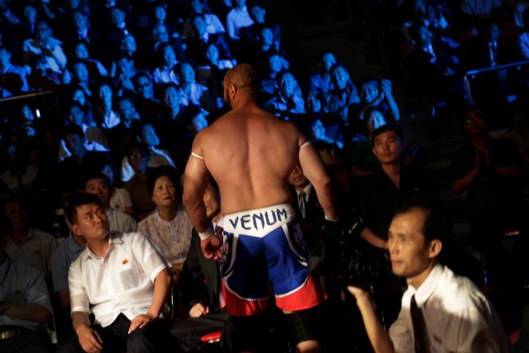 North Koreans watch a pro-wrestler leave the fighting arena after a match, Saturday, Aug. 30, 2014 in Pyongyang, North Korea. North Koreans got their first look at pro wrestling in about 20-years on Saturday when former NFL lineman Bob 