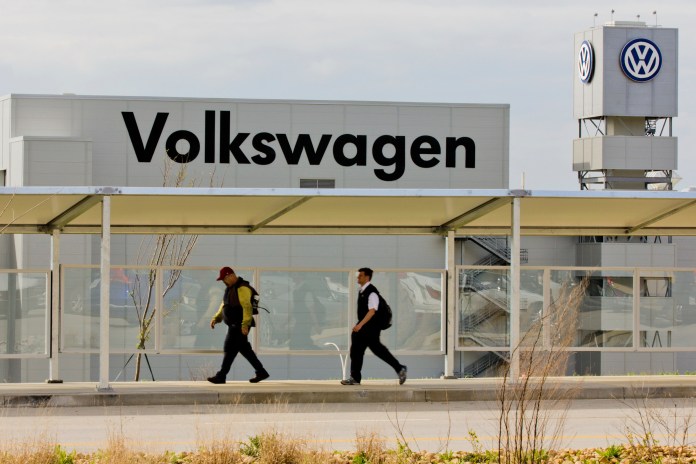 Workers walk by the Volkswagen AG plant in Chattanooga, Tenn., on Wednesday, March 21, 2012. (AP File)