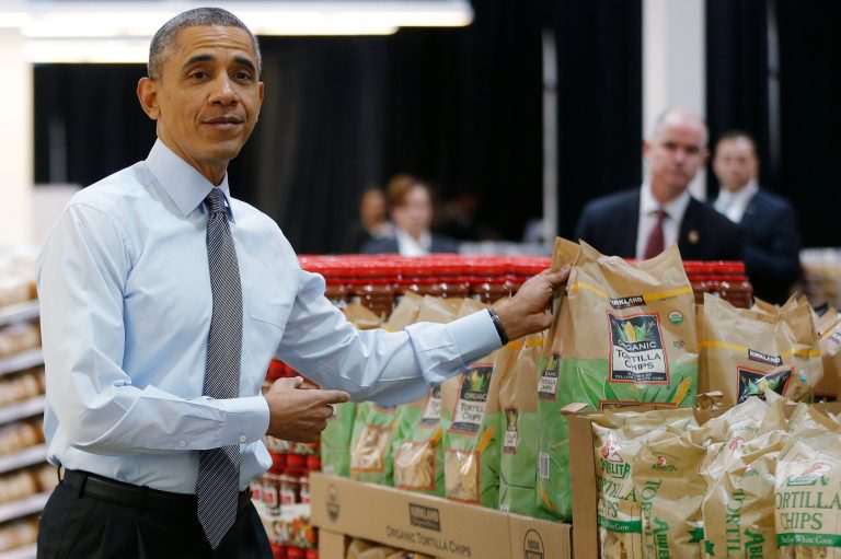 President Obama holds up a bag of tortilla chips at a Costco store in Lanham, Md., on Wednesday. Obama praised Costco in his State of the Union speech the night before. (AP Photo/Charles Dharapak)