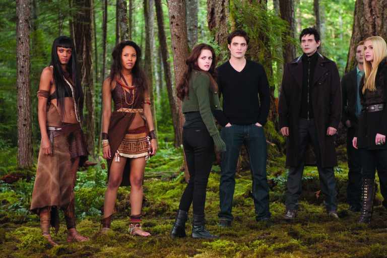 This undated publicity photo released by Summit Entertainment shows, from left, Judith Shekoni, Tracey Heggins, Kristen Stewart, Robert Pattinson, Christian Camargo, Peter Facinelli and Casey LaBow in a scene from the film, 