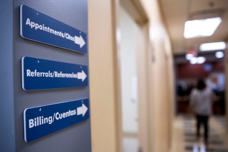 Appointments, referrals and billing signs hang on a wall at a Community Clinic Inc. health center in Greenbelt, Maryland, U.S., on Wednesday, April 8, 2015.