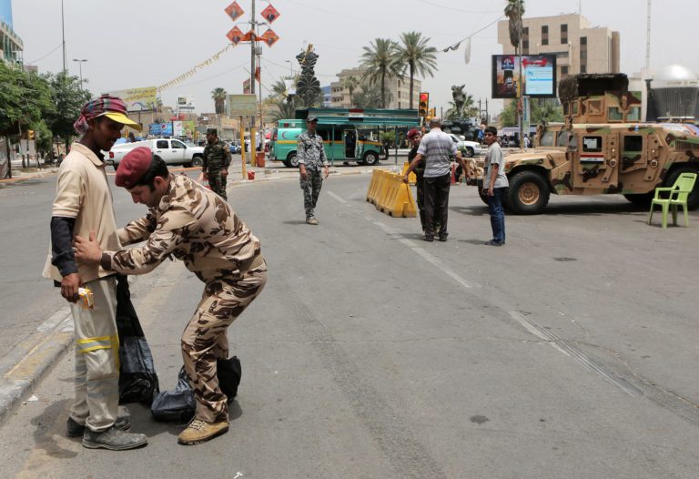 Iraqi security forces conduct body checks on Shiite pilgrims as they march to the shrine of Imam Moussa al-Kadhim in Baghdad, Iraq, Saturday, May 24, 2014. Shiite pilgrims are expected to converge on the shrine in northern Baghdad during their annual march to commemorate the eighth-century death of Imam Moussa al-Kadhim, a key Shiite saint. (AP Photo/Khalid Mohammed)