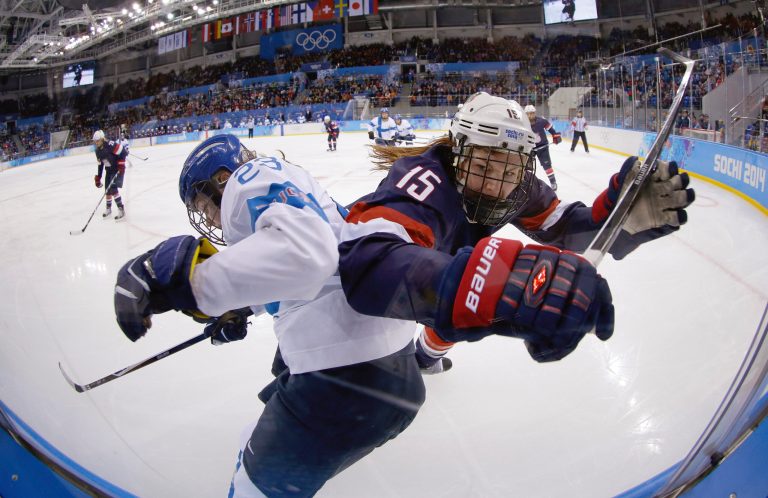 Nina Tikkinen of Finland and Anne Schleper of the United States battlers from control of the puck against the glass during the second period of the women's ice hockey game at the Shayba Arena during the 2014 Winter Olympics, Saturday, Feb. 8, 2014, in Sochi, Russia. (AP Photo/Matt Slocum)