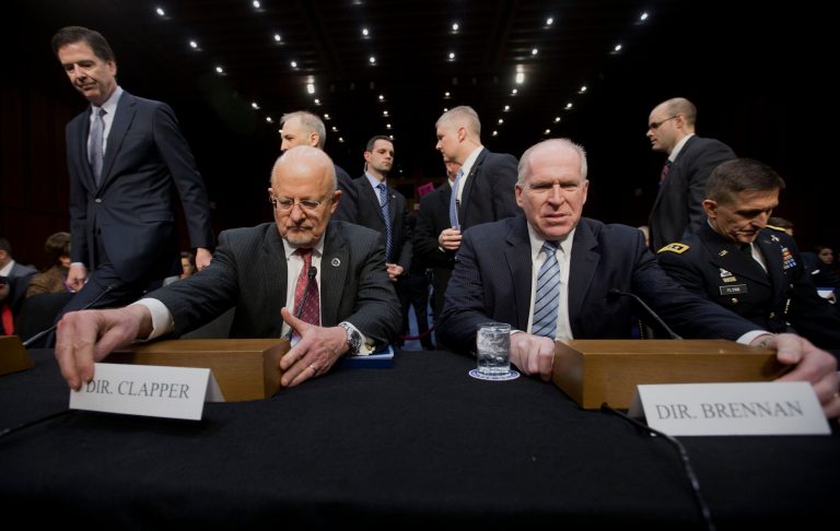 Director of National Intelligence James Clapper, left, and CIA Dir.ector John Brennan, right, take their seats on Capitol Hill in Washington, Wednesday, Jan. 29, 2014, prior to testifying before the Senate Intelligence Committee hearing on current and projected national security threats against the US. Also taking their seats on the panel are Defense Intelligence Agency Director Lt. Gen. Michael Flynn, right, and FBI Director James Comey, left. (AP Photo/Pablo Martinez Monsivais)