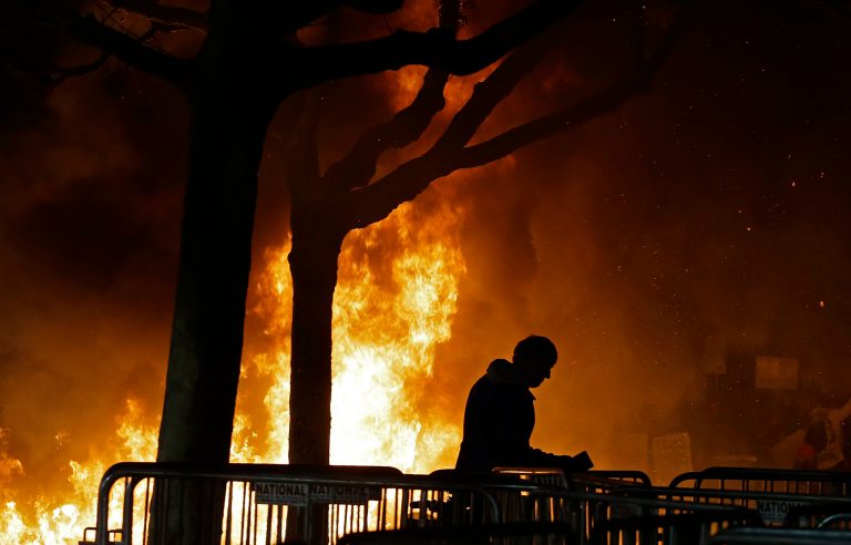 A bonfire set by demonstrators protesting a scheduled speaking appearance by Breitbart News editor Milo Yiannopoulos burns on Sproul Plaza on the University of California at Berkeley campus on Wednesday. President Trump threatened to take away federal funds from the school if it could not arrange for the speech to take place. (AP Photo/Ben Margot)