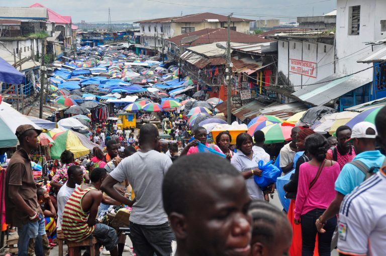 FILE - In this Aug. 19, 2014 file photo, people do business at the Waterside local market in the center of Monrovia, Liberia. Just as their economies had begun to recover from the man-made horror of coups and civil war, the West African nations of Guinea, Liberia and Sierra Leone have been knocked back down by the Ebola virus. (AP Photo/Abbas Dulleh, File)