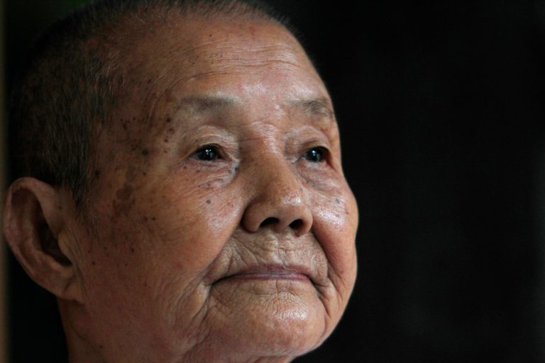 In this July 3, 2014 photo, Som Seng Eath, 86, widow of a dairy writer Poch Younly, pauses during an interview with the Associated Press in her home, in Phnom Penh, Cambodia. Nearly 40 years ago, Cambodian school inspector Poch Younly kept a secret diary vividly recounting the horrors of life under the Khmer Rouge, the radical communist regime whose extreme experiment in social engineering took the lives of 1.7 million Cambodians who died of overwork, medical neglect, starvation and execution.(AP Photo/Heng Sinith)