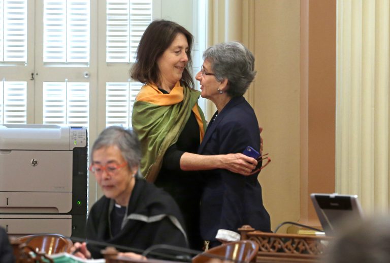Assemblywoman Nancy Skinner, D-Berkeley, left, hugs State Sen. Hannah-Beth Jackson, D-Santa Barbara, after the bill they co-authored, along with Assemblyman Das Williams, D-Santa Barbara, that will allow courts to issue temporary 