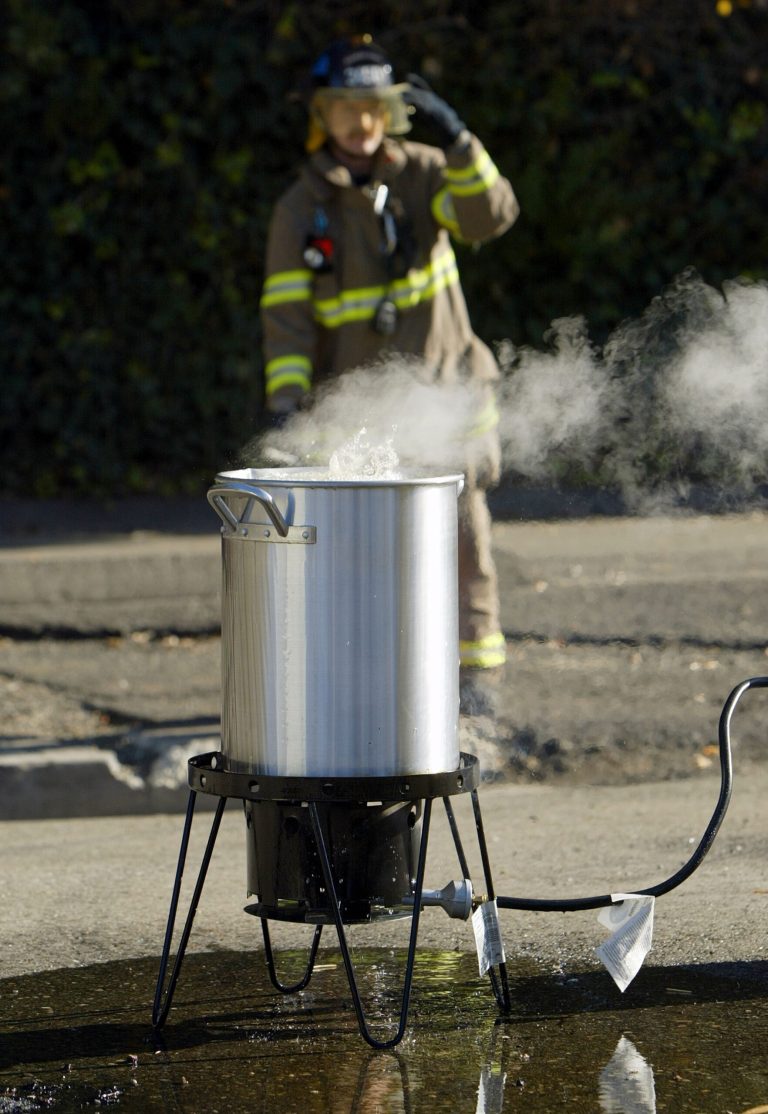 A firefighter monitors a turkey fryer full of  boiling oil during a safety demonstration. (Getty Images)