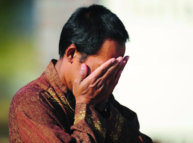 Imam Lahmuddin holds his hands over his face after a fire destroyed the Islamic Society of Joplin, Mo., mosque, Monday, Aug. 6, 2012, in Joplin, Mo. The fire was the second fire to hit the Islamic center in little more than a month. (AP Photo/The Joplin Globe, T. Rob Brown) MANDATORY CREDIT