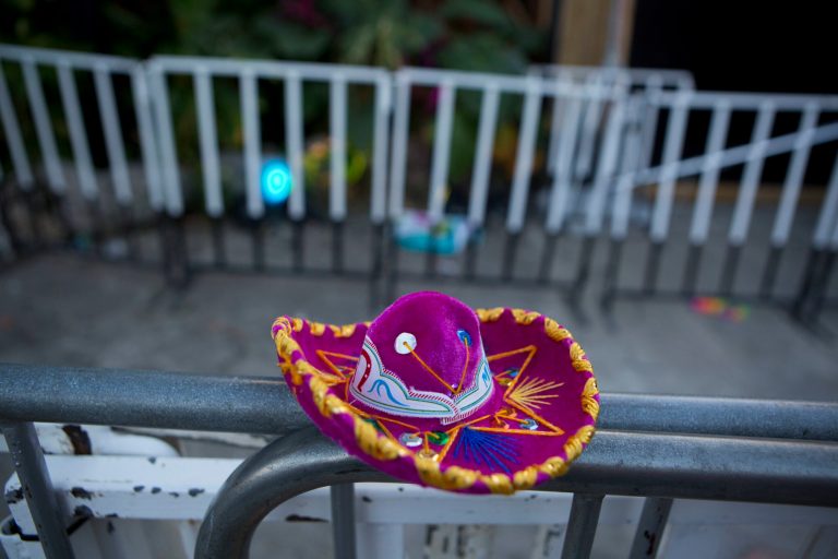A Mexican tourist souvenir placed by a well-wisher sits on barriers blocking the entrance to the Blue Parrot club, where several people were killed in early morning gunfire, in Playa del Carmen, Mexico, Monday, Jan. 16, 2017. Deadly gunfire broke out in the crowded beachfront nightclub throbbing with electronic music before dawn on Monday, setting off a bloody stamped by screaming concertgoers at an international festival in this Caribbean resort.(AP Photo/Rebecca Blackwell)