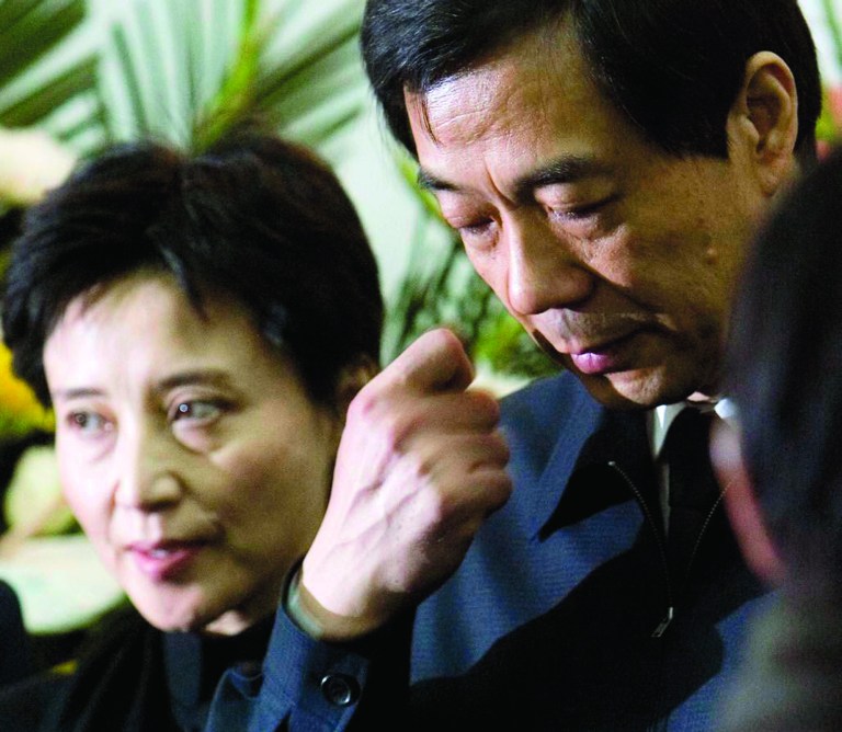 FILE - In this Jan. 17, 2007 file photo, former Chongqing Communist Party Secretary Bo Xilai, right, accompanied by his wife Gu Kailai, attends a funeral for his father in Beijing. Chinese prosecutors were charging Gu and a family aide with the murder of a British businessman, the official Xinhua News Agency reported Thursday, July 26, 2012. (AP Photo/Kyodo News/China Foto Press) JAPAN OUT, MANDATORY CREDIT, NO LICENSING IN CHINA, HONG KONG, JAPAN, SOUTH KOREA AND FRANCE, NO SALES