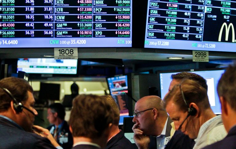 FILE- In a July 13, 2012, file photo, traders work as the New York Stock Exchange nears closing. JPMorgan Chase blew away a cloud of concern hanging over the banking industry Friday and set off a rally in stocks. Relieved investors drove up bank stocks, ended a six-day losing streak for the market and sent the Dow Jones industrial average up 204 points, the best day this month.  (AP Photo/Bebeto Matthews)