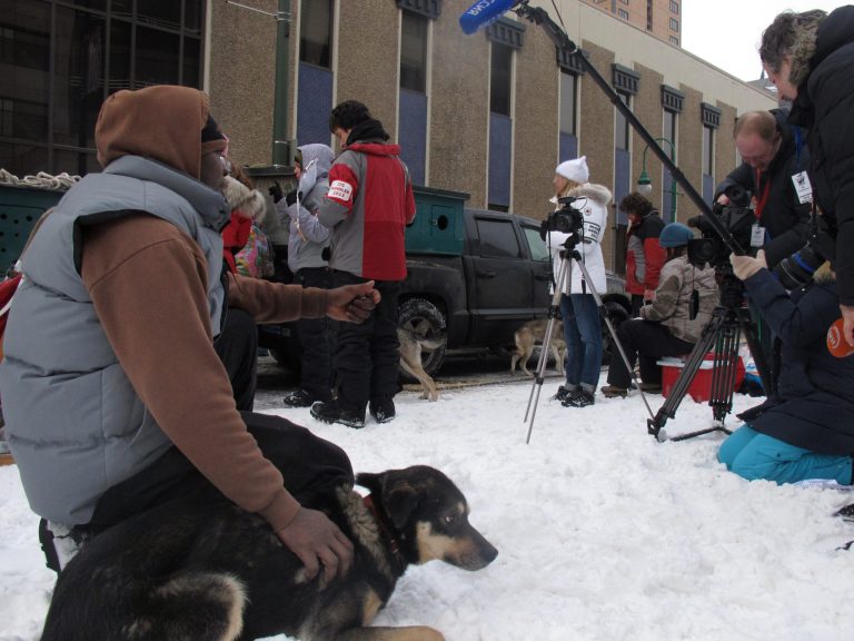 Jamaican musher Newton Marshall is interviewed by international media before the ceremonial start of the 2013 Iditarod Trail Sled Dog Race in Anchorage, Alaska on Saturday, March 2, 2013. The race, which will take mushers about a thousand miles across the Alaska wilderness, starts Sunday, March 3, 2013, in Willow, Alaska. (AP Photo/Mark Thiessen)