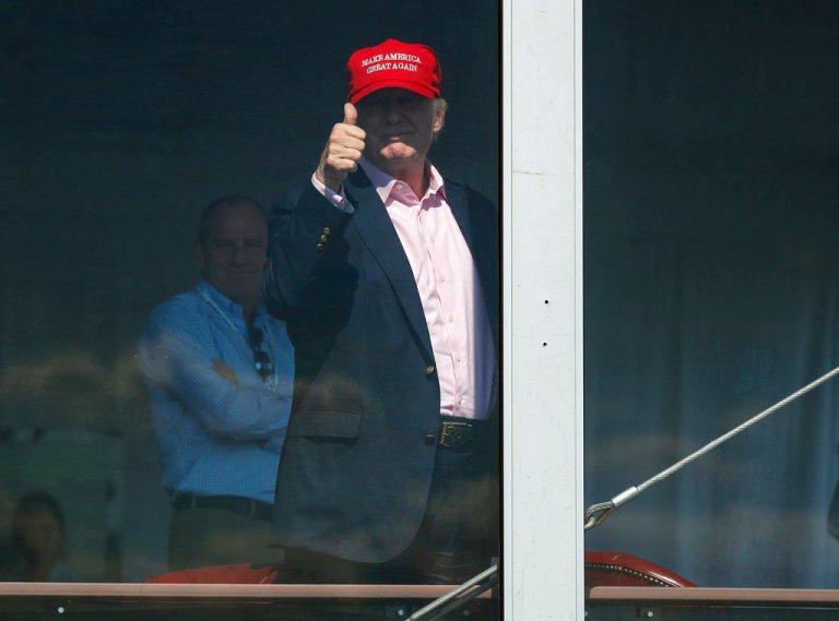 President Donald Trump gives a thumbs-up from his presidential viewing stand, Sunday, July 16, 2017, during the U.S. Women's Open Golf tournament at Trump National Golf Club in Bedminster, N.J. (AP Photo/Carolyn Kaster)
