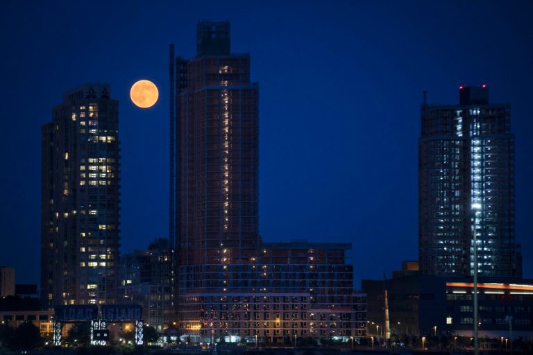 A perigee moon, also known as a supermoon, rises over the Queens borough of New York, Saturday, July 12, 2014. The phenomenon, which scientists call a 
