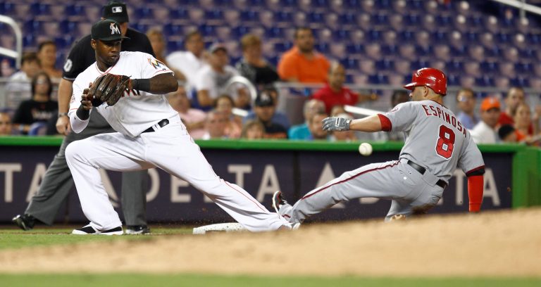 Washington Nationals runner Danny Espinosa (8) slides into third safe on a second inning triple and a late throw to Miami Marlins' Hanley Ramirez (2) during a baseball game in Miami, Monday, July 16, 2012.  (AP Photo/J Pat Carter)