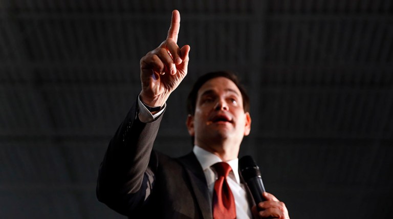 On stage, Rubio dismissed Trump's claim that he's tough on immigration, and said Trump has been fined for hiring illegal immigrants. (AP Photo/Paul Sancya)