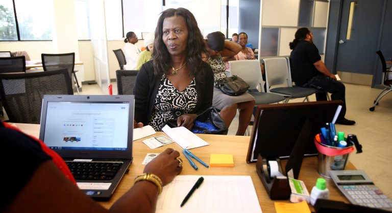 A woman works with a counselor at Miami's Borinquen Health Center to get signed up for health insurance through Obamacare on Dec. 2. (AP Photo/J Pat Carter)