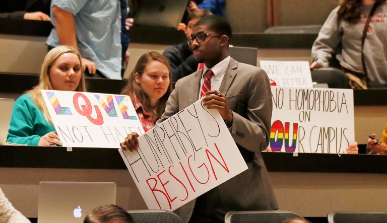 University of Oklahoma Student Government president holds a sign favoring the resignation of Regent Kirk Humphreys. The regent made comments comparing gay people to pedophiles. Humphreys issued a statement to KFOR, apologizing for his comments as well as granting a bit of transparency from his perspective on the heated matter. (AP Photo/Sue Ogrocki)