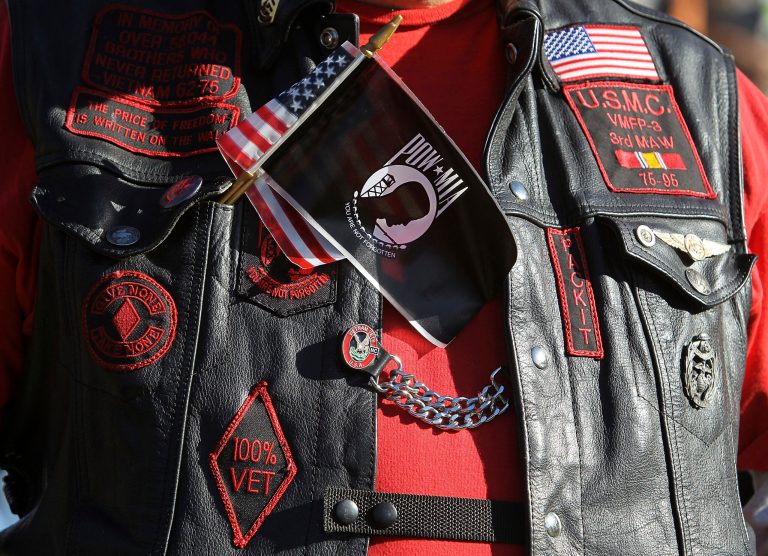A veteran wears a U.S. and POW-MIA flag together on his vest during a Veterans Day event at the Vietnam Veterans Memorial November 11, 2010 in Washington. (Photo by Alex Wong/Getty Images)