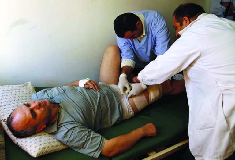 Palestinian lawmaker Shami Al-Shami, 47, is treated by medics for gun wounds sustained outside his home in the West Bank town of Jenin, Sunday, July 1, 2012. Al-Shami said Sunday he has been shot twice in the leg by assailants as he got out of his car outside his home. Jenin once served as a model for Palestinian law and order, but has experienced a wave of brazen attacks by gunmen over the past year. (AP Photo/Mohammed Ballas)