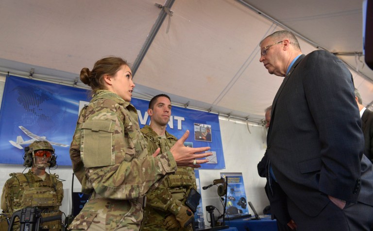 Air Force 1st Lt. Caroline Kurtz, a human factors engineer with the Air Force Research Laboratory, briefs Deputy Defense Secretary Bob Work on wearable technology systems as he tours exhibits during DoD Lab Day at the Pentagon, May 14, 2015. At center is behavioral scientist Air Force 2nd Lt. Anthony Eastin. (Courtesy of the Department of Defense/Glenn Fawcett)