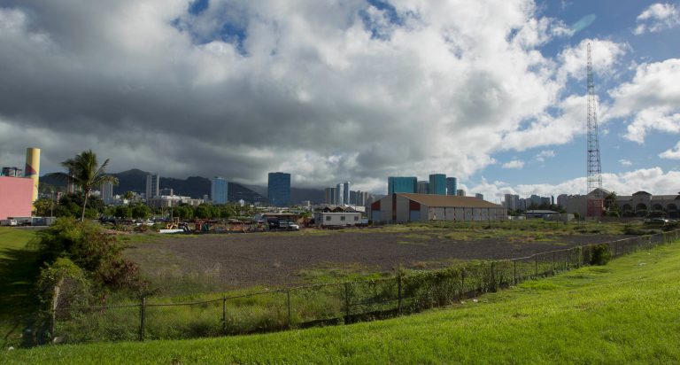 FILE - This Dec. 24, 2013, file photo photo shows one possible location in the Kakaako district of Honolulu to be considered for the Barack Obama Presidential Library. The location is considered prime real estate with views of the ocean and Koolau mountains.  Chicago, New York and Honolulu are on the short list to host President Barack Obama's future presidential library. The Barack Obama Foundation says four of the 13 applications submitted earlier this year made the cut. New York's Columbia University and the University of Hawaii are being invited to submit more formal proposals to host the library. So are two Illinois schools: the University of Chicago and the University of Illinois at Chicago. (AP Photo/Eugene Tanner)
