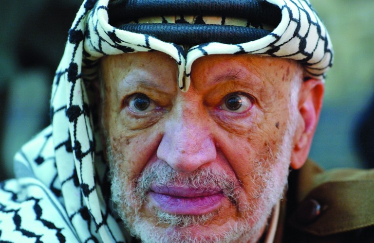FILE - In this Saturday, Oct. 2, 2004 file photo, Palestinian leader Yasser Arafat pauses during an emergency cabinet session, at his compound, in the West Bank town of Ramallah. Yasser Arafat's body may be exhumed to allow for more testing of the causes of his death, the Palestinian president said Wednesday, July 4, 2012, after a Swiss lab said it found elevated levels of a radioactive isotope in belongings the Palestinian leader is said to have used in his final days.(AP Photo/Muhammed Muheisen, File)