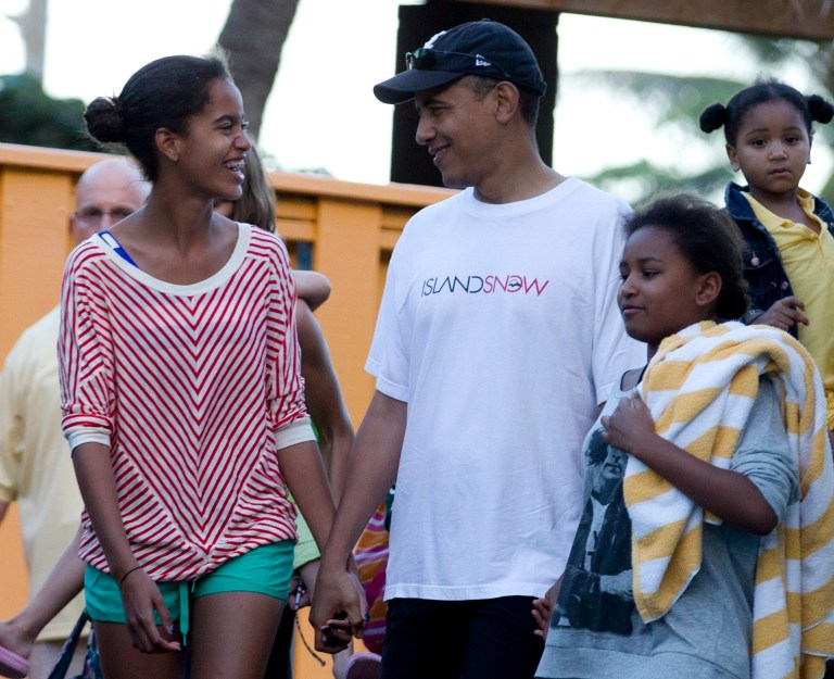 President Obama holds hands with his daughters Malia, left, and Sasha, right, as they leave Sea Life Park in Waimanalo, Hawaii, in December 2011. (AP Photo/Carolyn Kaster)