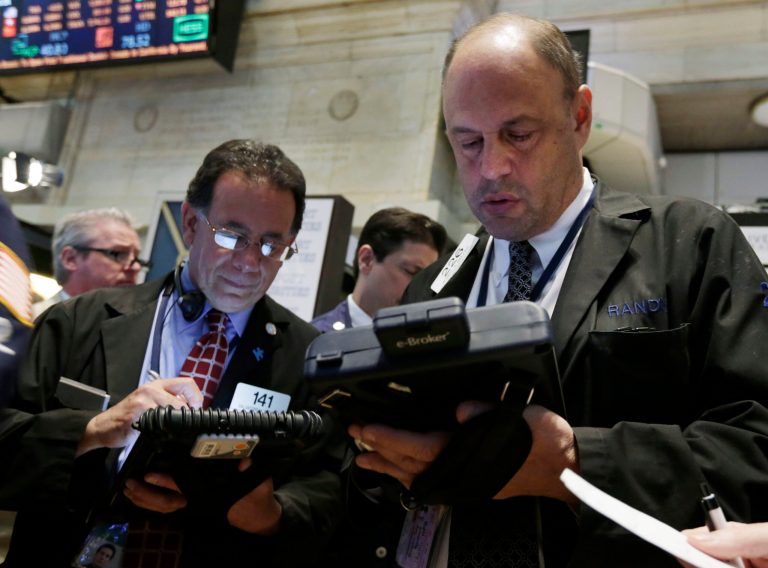 Randy Beller, right, works with fellow traders on the floor of the New York Stock Exchange Thursday, April 24, 2014. Mixed earnings from a large number of U.S. companies left the stock market without direction early Thursday, despite positive results from a handful of names including Apple and Caterpillar. (AP Photo/Richard Drew)