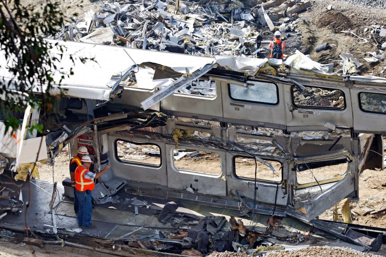   File - This Sept. 14, 2008 file photo shows investigators photographing the mangled inside of a Metrolink commuter train in Chatsworth, Calif. Despite a rash of deadly train crashes, the railroad industryâs allies in Congress are trying to push back the deadline for installing technology to prevent the most catastrophic types of collisions to at least 2020, half a century after accident investigators first called for such safety measures. (AP Photo/Richard Vogel, File)  