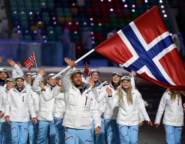 Aksel Lund Svindal of Norway carries the national flag as he leads the team during the opening ceremony of the 2014 Winter Olympics in Sochi, Russia, Friday, Feb. 7, 2014. (AP Photo/Mark Humphrey)
